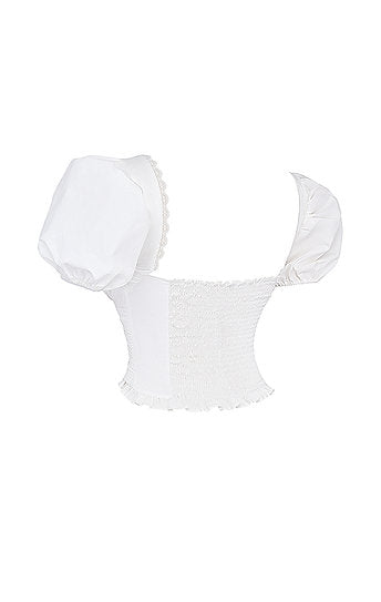 Saskia — Conjunto: blusa encauchada y falda short mini con lazo