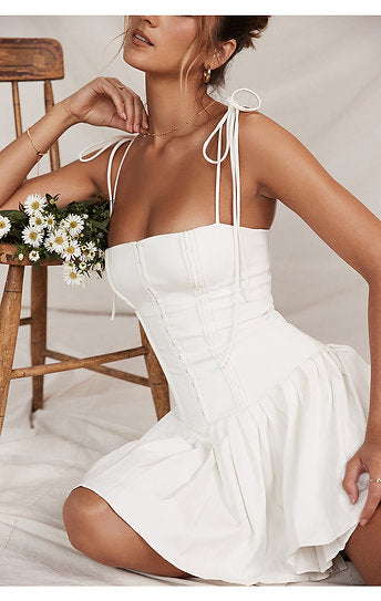 Vianne — Vestido mini con lazos y falda plisada